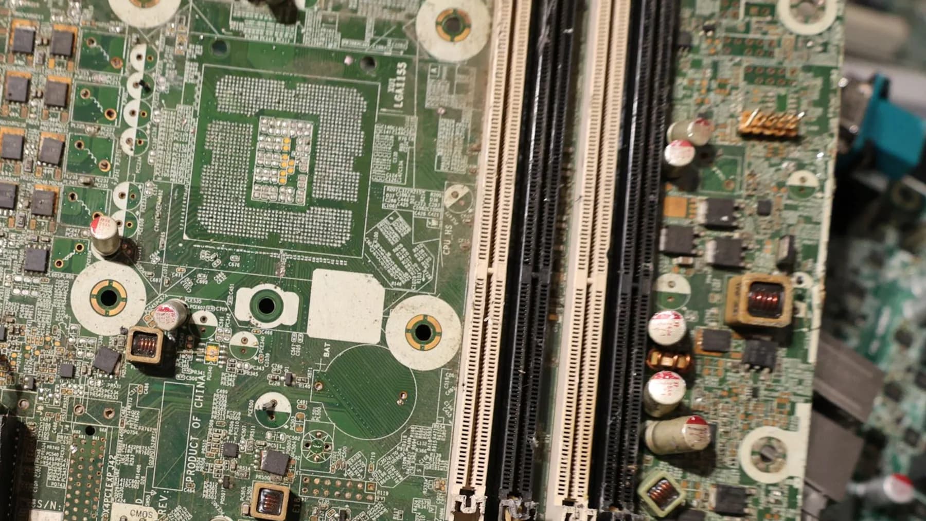 Close-up of stripped computer circuit boards and memory slots stacked together as electronic waste