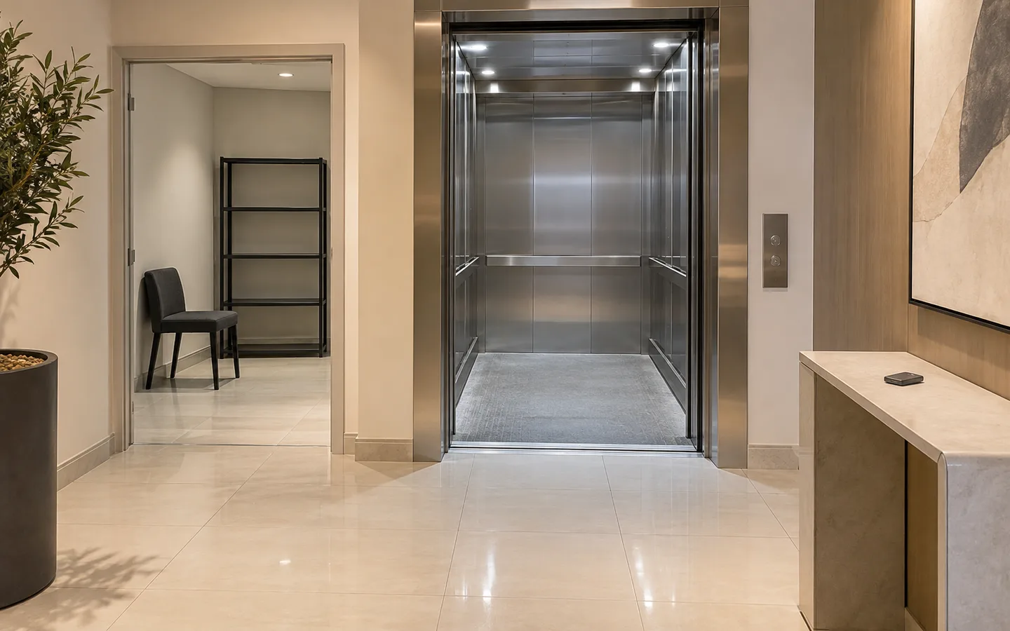 Open service lift and clear tiled approach prepared for a scheduled Dubai pickup, with an unbranded furniture dolly parked aside