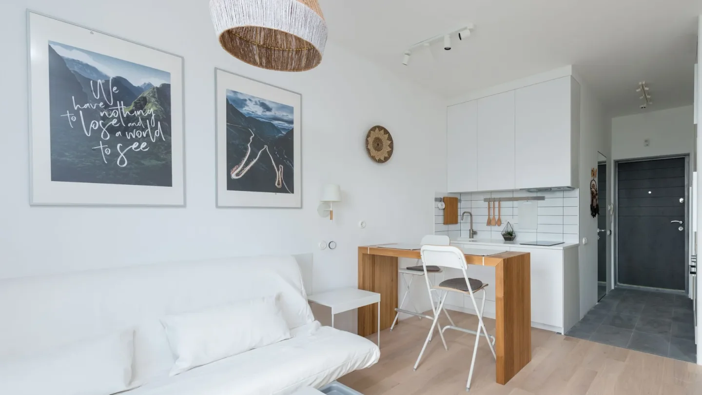 Low-rise apartment living room in The Greens Dubai with sofa bed, dining table, and organized move-out items