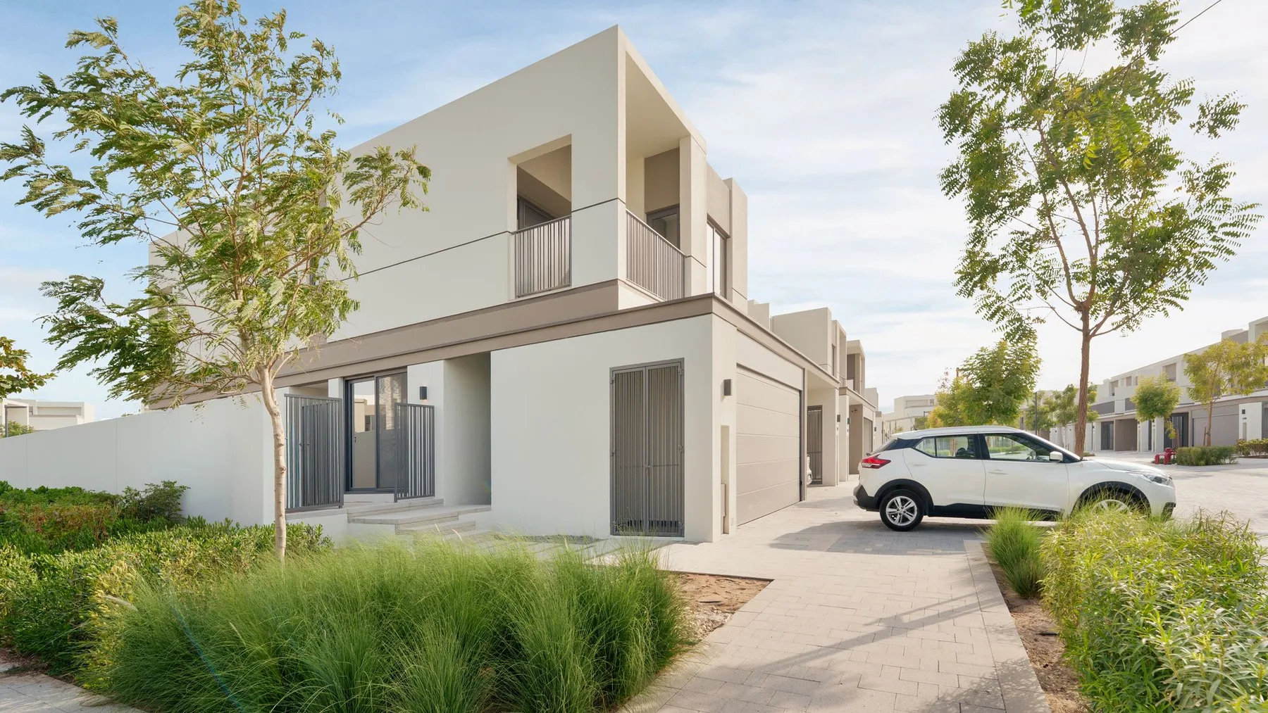 Contemporary villa in a Dubai residential community with a car parked on the driveway