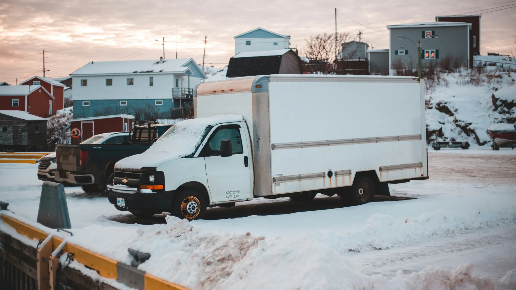 White enclosed commercial box truck parked in a clean paved logistics area