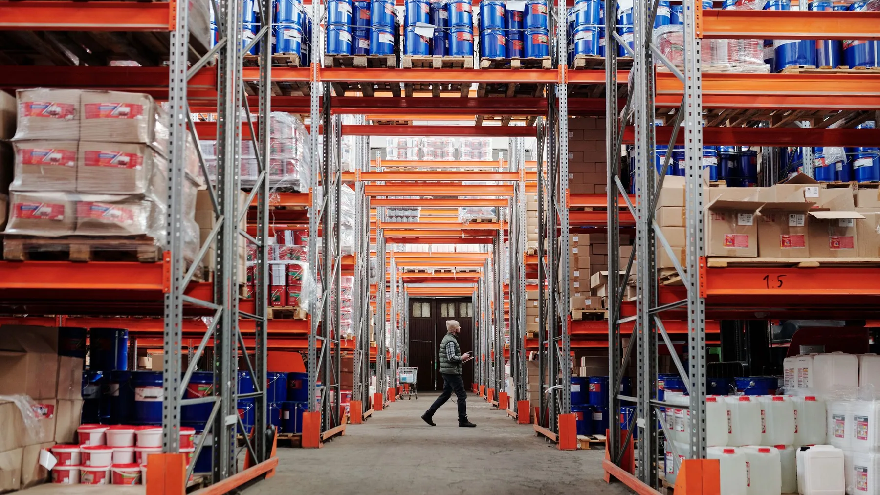 Steel storage shelving and stacked boxes in an organized garage workspace