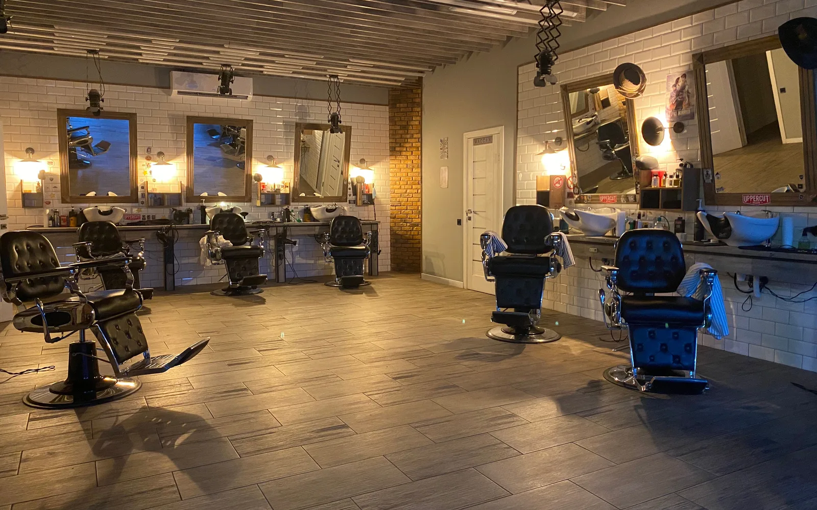 Commercial barber shop styling stations with heavy hydraulic chairs and mirrors