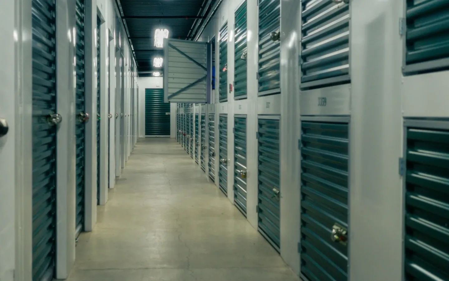 Clear corridor of shuttered storage units showing the shared route to keep open during a cleanout