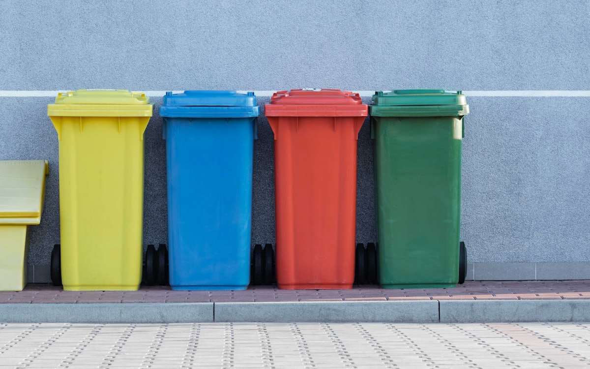 Row of large wheeled bins ready for garbage removal Dubai collection